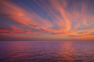 Dramatic sunset over sea surface, outdoor background