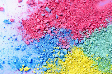 Colorful background of chalk powder. Color dust particles splattered on white background.