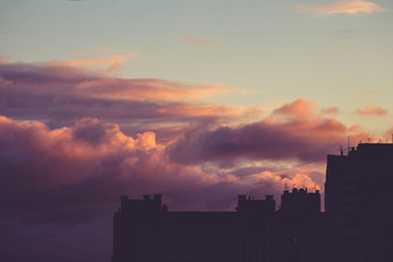 Obraz premium blue purple sunset clouds house roof