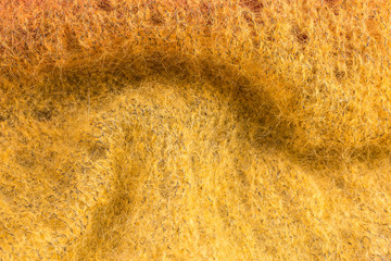 background of knitted shawl in yellow mohair and silk wool