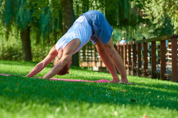 Man doing yoga exercises outdoor in the park