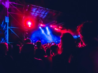 The party, concert concept. Crowd raising their hands and enjoying great rock festival. blur bokeh...