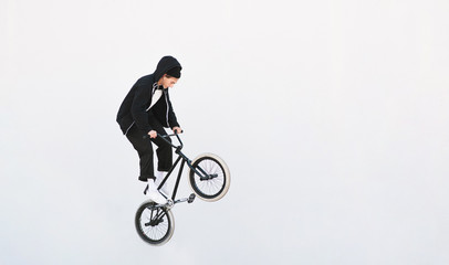 BMX freestyle. Young BMX bicycle makes tricks on the white background. Copyspace7 Bmx trick on a white background