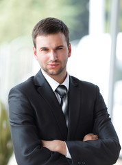 successful businessman standing near window in office.