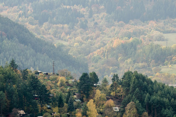 Small cabins in the mountains - autumn forest landscape