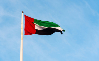 United Arab Emirates flag against blue sky