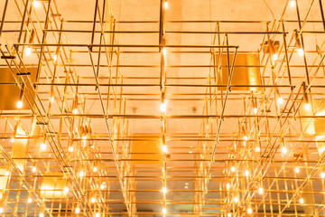 Modern metal lighting construction on the ceiling that looks like bamboo