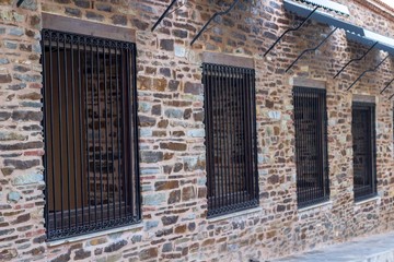 Perspective shoot of iron bar windows on masonry old inn in local places of Turkey