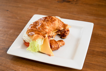 Cheese hams croissant served on the table.