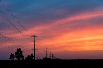 Rural landscape with power poles at sunrise