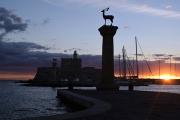 Fototapeta premium Dawn in the resort town of Rhodes. The port of Rhodes,Greece.Autumn.Landscape in the rainy season.