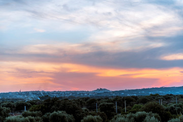 Panoramic view of the medieval white village of Ostuni at sunset golden hour