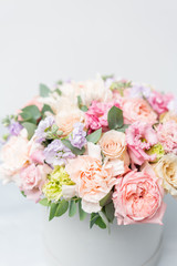 Beautiful spring bouquet in round box. Arrangement with various flowers. The concept of a flower shop. A set of photos for a site or catalogue. Work florist.