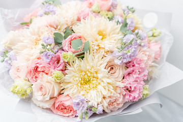 Beautiful spring bouquet in glass vase. Arrangement with various flowers. The concept of a flower shop. A set of photos for a site or catalogue. Work florist.