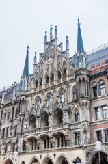 Fototapeta na wymiar Fragment of New Town Hall of Munich (Neues Rathaus) neo-Gothic style palace in Marienplatz, the town square in historic center. Germany, Europe