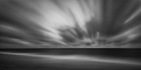 Dramatic long exposure seascape on the beach of Faro, Portugal.
