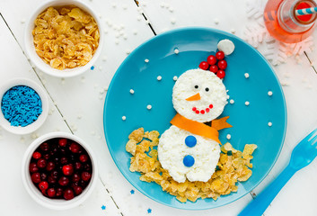 Healthy breakfast idea for kids - christmas snowman from cottage cheese and corn flakes, food art...