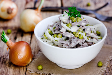 Meat, onion and peas mixed salad, russian cuisine