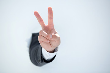 businessman hand showing a gesture of victory