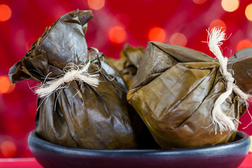 Traditional Colombian tamale as made on Tolima region over a christmas red background