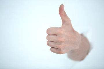 hand gesture with thumb up on a light background