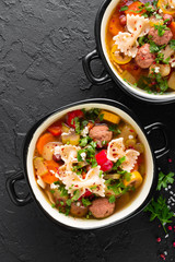 Italian minestrone soup with beef meatballs, vegetables and pasta in bowl