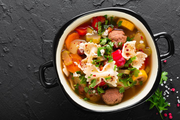 Italian minestrone soup with beef meatballs, vegetables and pasta in bowl