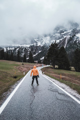 Man with camera standing on the road