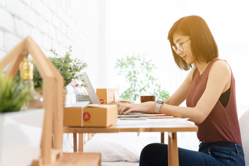 Woman small business owner, business start up conceptual, young entrepreneur work with laptop while have coffee