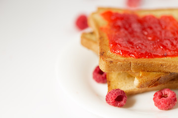 Toast with jam in white plate and place for text
