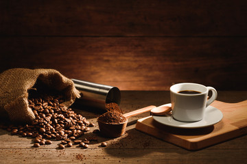 A shot of espresso with roasted coffee bean, grounded and  coffee grinder