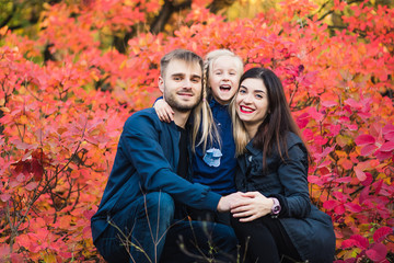 Happy family smiling portrait in autumn forest