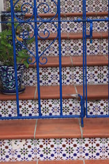 Brown steps in blue tile with patterns