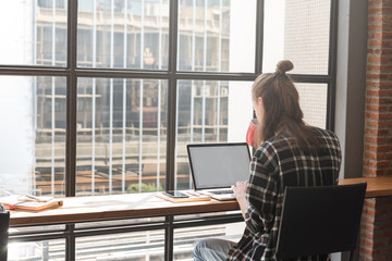 Russian teenage freelance work with laptop in coffee shop