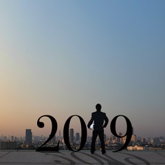 businessman stand on roof top with conceptual of year 2019