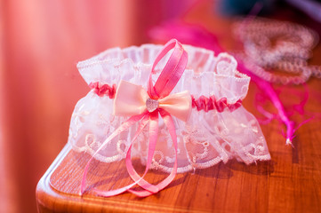 Bride's pink garter on the table