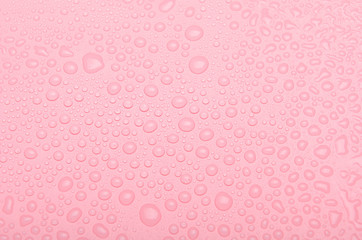 Drops of water on a pink background. Top view