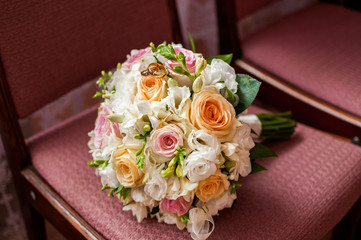 Wedding rings on bouquet of roses