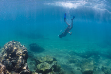 A girl with mask exploring underwater in the Mediterranean Sea