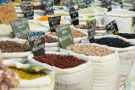 Grains of beans of several kinds and colors in sacks at a free street fair in Brazil