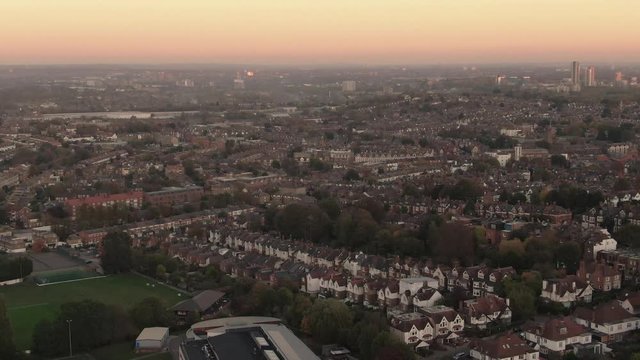 Aerial panning view of the skyline of London from the North at sunset