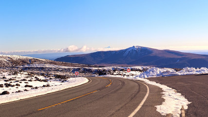 Winter road in Tongariro National Park with Mt Taranaki in the distance, New Zealand