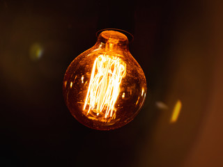 vintage lightbulb with dark background with lens flares