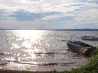 Obraz premium River Bay. Beautiful sky with clouds. Fishing boats. Russian summer nature. Russia, Ural, Perm region