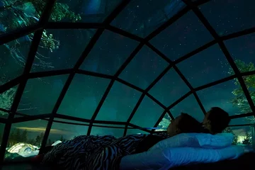 Foto op Aluminium CLOSE UP Young Caucasian tourist couple observing the night sky from glass house © helivideo