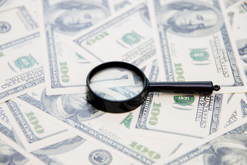 Magnifying glass on your american dollar bill as a background