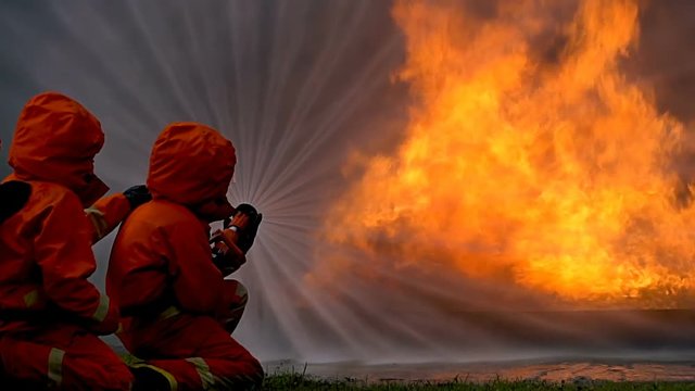 Fireman useing fire hydrant to stop a flame. They use many style of water to stop burning.