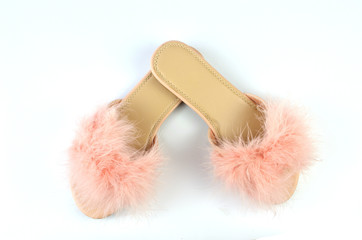 Flat pink feather slippers in a crossed position