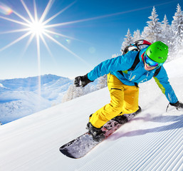 Man snowboarder riding on slope.