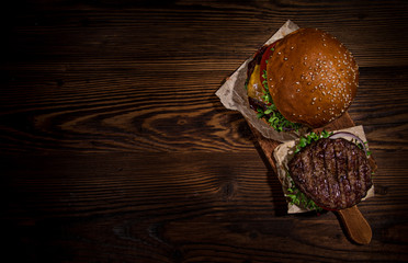 Top view of tasty burgers on wooden table.
